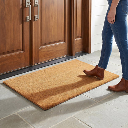 Ecomills Natural Coir Doormat 36 x 48 lifestyle image with woman model for scale
